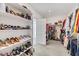 Large walk-in closet with custom shelving and hanging rods at 7747 Harthill Park Ave, Las Vegas, NV 89113