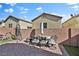 Red brick backyard patio features seating and lush greenery at 7868 Running Doe Ct, Las Vegas, NV 89149