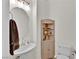 Cozy powder room with pedestal sink, round mirror, and charming decorative shelving at 7868 Running Doe Ct, Las Vegas, NV 89149