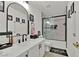 Modern bathroom with white vanity, subway tile, and black accents at 7868 Running Doe Ct, Las Vegas, NV 89149