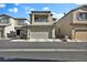 Two-story home featuring a two car garage, covered porch, and small balcony at 7868 Running Doe Ct, Las Vegas, NV 89149