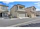 Two-story home featuring a two car garage, covered porch, and small balcony at 7868 Running Doe Ct, Las Vegas, NV 89149