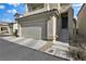 Attached garage with stairs leading to the home's entrance at 7868 Running Doe Ct, Las Vegas, NV 89149