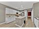 Modern kitchen with white cabinets, an island, and hardwood floors at 7868 Running Doe Ct, Las Vegas, NV 89149