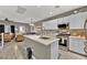 Modern kitchen with island, stainless steel appliances, and white cabinets at 7868 Running Doe Ct, Las Vegas, NV 89149