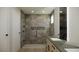 Modern bathroom with double vanity, walk-in shower, and pebble floor at 8316 Broad Peak Dr, Las Vegas, NV 89131