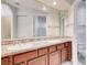 Double vanity bathroom with granite countertop and wood cabinets at 8600 Kiel Ridge Cir, Las Vegas, NV 89117