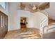 Grand entryway with a curved staircase, tile flooring, and a large chandelier at 8600 Kiel Ridge Cir, Las Vegas, NV 89117