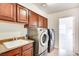 Laundry room with washer, dryer, cabinets and a utility sink at 8600 Kiel Ridge Cir, Las Vegas, NV 89117