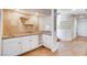 Wet bar with granite countertop, white cabinets, and wine rack at 8600 Kiel Ridge Cir, Las Vegas, NV 89117