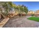 Landscaped backyard with artificial turf and trees at 9178 Sunken Meadow Ave, Las Vegas, NV 89178