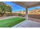 Backyard with covered patio and artificial turf at 9178 Sunken Meadow Ave, Las Vegas, NV 89178