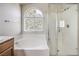 Bathroom with soaking tub, shower, and window at 9178 Sunken Meadow Ave, Las Vegas, NV 89178