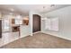 Bright dining room adjacent to kitchen, featuring a chandelier and neutral decor at 9178 Sunken Meadow Ave, Las Vegas, NV 89178