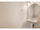 Simple powder room with pedestal sink and oval mirror at 9178 Sunken Meadow Ave, Las Vegas, NV 89178