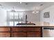 Kitchen island with granite countertop, double sink, and modern faucet at 9217 Quartz Hills Ave, Las Vegas, NV 89178