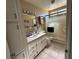 Clean bathroom with white vanity, shower, and tiled flooring at 936 Elon Ln, Indian Springs, NV 89018