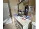 Bathroom features vanity with sink, tiled backsplash, and mirror at 936 Elon Ln, Indian Springs, NV 89018