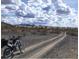 Dirt road in the desert with a motorcycle parked at 936 Elon Ln, Indian Springs, NV 89018