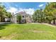 Expansive backyard featuring lush lawn, mature trees, and a glimpse of the inviting pool at , Las Vegas, NV 89128