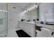 This spacious bathroom features a large mirrored wall, double sinks and glass enclosed shower at 2604 Sun Reef Rd, Las Vegas, NV 89128