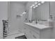 Bathroom showcasing a glass-enclosed shower, single sink vanity with white countertops and cabinetry, and modern lighting at 2604 Sun Reef Rd, Las Vegas, NV 89128