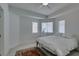 This bedroom features wood-look flooring, ceiling fan and three windows at 2604 Sun Reef Rd, Las Vegas, NV 89128