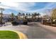 A grand community entrance with brick pavers, lush landscaping and a gated entrance at 2604 Sun Reef Rd, Las Vegas, NV 89128