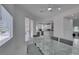 Bright dining room with glass table, gray chairs, and views of kitchen and pool at , Las Vegas, NV 89128