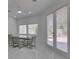 Dining room with modern chairs and glass table set, complemented by large windows at 2604 Sun Reef Rd, Las Vegas, NV 89128