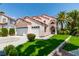 Two-story house with a three-car garage and landscaped yard at 2604 Sun Reef Rd, Las Vegas, NV 89128