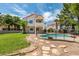 A refreshing pool with a secure fence surrounds a beautiful two-story home with a balcony at 2604 Sun Reef Rd, Las Vegas, NV 89128