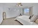 Bright bedroom with plush carpet, a queen-sized bed, and natural light from the window at 10424 Wyatt Earp Ct, Las Vegas, NV 89129