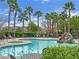 Community pool with spa, waterfall feature, and lounge chairs at 10424 Wyatt Earp Ct, Las Vegas, NV 89129