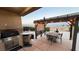 Outdoor kitchen, pergola, dining area, mountain views at 10470 W Ann Rd Rd, Las Vegas, NV 89149