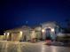 Well-lit house exterior at night, featuring a three-car garage at 10470 W Ann Rd Rd, Las Vegas, NV 89149