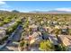 Aerial view of house and neighborhood with mountain backdrop at 10636 Amblewood Way, Las Vegas, NV 89144