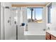 Bathroom with soaking tub, shower and large window at 10636 Amblewood Way, Las Vegas, NV 89144