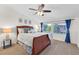 Spacious bedroom with a ceiling fan and large windows at 10636 Amblewood Way, Las Vegas, NV 89144