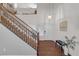 Inviting entryway with hardwood floors and wooden staircase at 10636 Amblewood Way, Las Vegas, NV 89144