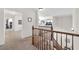 Upstairs hallway with carpet, wood railing and views into other rooms at 10636 Amblewood Way, Las Vegas, NV 89144