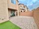 Private backyard with paver patio, artificial turf, and grill at 10636 Tulip Valley Rd, Las Vegas, NV 89179