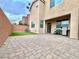 Private backyard with paver patio, artificial turf, and grill at 10636 Tulip Valley Rd, Las Vegas, NV 89179