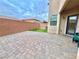 Private backyard with paver patio and artificial turf at 10636 Tulip Valley Rd, Las Vegas, NV 89179