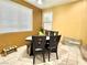 Cozy dining area with triangular table and four chairs near window at 10636 Tulip Valley Rd, Las Vegas, NV 89179