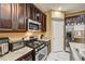 Kitchen with dark cabinets, granite counters, and stainless steel appliances at 10636 Tulip Valley Rd, Las Vegas, NV 89179