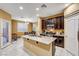 Kitchen with island, dark cabinets, granite counters, and stainless steel appliances at 10636 Tulip Valley Rd, Las Vegas, NV 89179