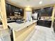 Spacious kitchen with dark cabinetry, granite island, and stainless steel appliances at 10636 Tulip Valley Rd, Las Vegas, NV 89179