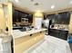 Spacious kitchen with dark cabinetry, granite island, and stainless steel appliances at 10636 Tulip Valley Rd, Las Vegas, NV 89179