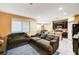 Living room with brown sofa and view of open kitchen at 10636 Tulip Valley Rd, Las Vegas, NV 89179